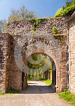 Archway and gate in old castle wall