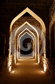 Archway inside Bahrain fort at night