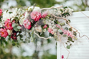 Archway of many beautifil flowers, wedding arch with peones. Ceremony.