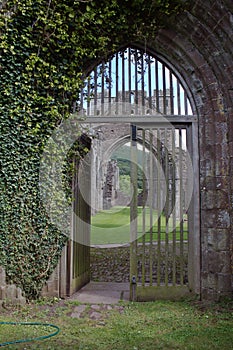 Archway with wooden gates at old abbey in Brecon Beacons in Wales