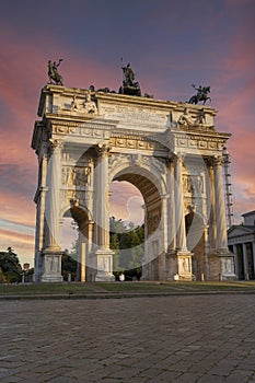 Arco della pace in Milan at sunset. Detail of the clock tower of the Sforza Castle XV century Castello Sforzesco . It is one of