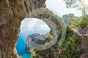 Arco Naturale is natural arch on coast of Capri island, Italy photo