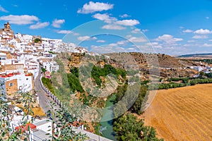 Arcos de la Frontera reflected on river Guadalete in Spain photo