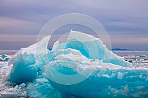 Arctic blue glacier ice hummock in cloudy weather