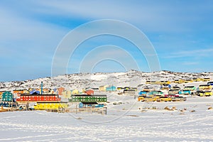 Arctic city center with colorful Inuit houses on the rocky hills covered in snow, Ilulissat, Avannaata municipality, Greenland