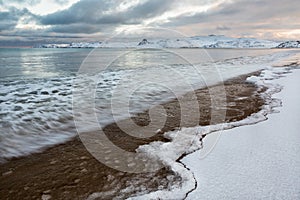 Arctic coast at sunrise in winter. Barents Sea. Kola Peninsula.