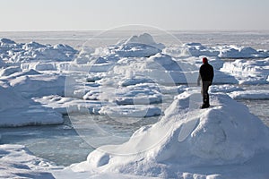 Arctic landscape, a man on the frozen fjord photo