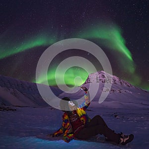 Arctic Northern lights aurora borealis sky star in Norway travel blogger girl man Svalbard in Longyearbyen city the moon mountains