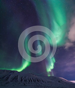Arctic Northern lights aurora borealis sky star in Norway travel Svalbard in Longyearbyen city the moon mountains