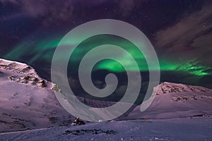 Arctic Northern lights aurora borealis sky star in Norway travel Svalbard in Longyearbyen city the moon mountains