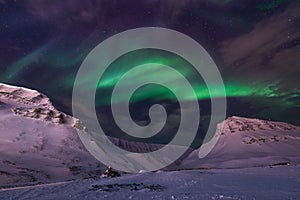 Arctic Northern lights aurora borealis sky star in Norway travel Svalbard in Longyearbyen city the moon mountains