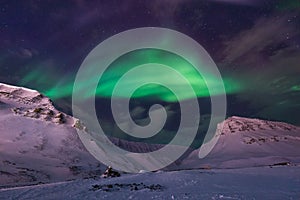 Arctic Northern lights aurora borealis sky star in Norway travel Svalbard in Longyearbyen city the moon mountains