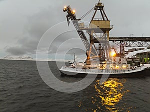 Arctic port in the Russian settlement of Barentsburg on Spitsbergen in the initial period of the polar night photo