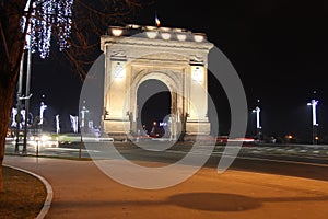 Arcul de Triumf by night in winter photo