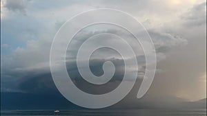 Arcus storm over lake. Landscape of Lake Geneva, mountains and sky at sunset. Dramatic sky. Arcus cloud. Storm cloud.