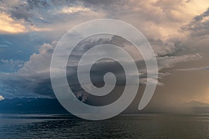 Arcus storm over lake. Landscape of Lake Geneva, mountains and sky at sunset. Lausanne, Switzerland