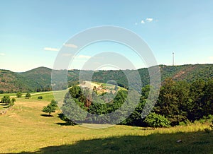 Ardennes of Luxembourg: View over field into valley of river Sauer in district Diekirch