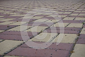 Area of a lock pavement in the bright red and yellow color in the shapes of rectangles and rhombus