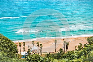 Areal shot of beautiful Jeju island beach with lots of enthusiastic surfers swimming i