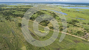 Areal view of green rural landscape with lakes and waterways near Mompos, Colombia