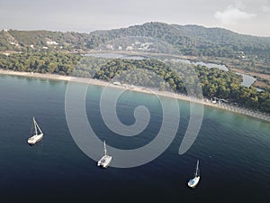 Areal view of Koukounaries beach at Skiathos and three sailboats