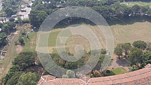 Areal view of the playground of Godrej Udayachal high school. The grass is being cleared with lawn movers. Preparation for