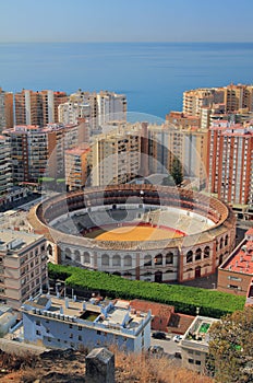 Arena for bullfight and city on sea coast. Malaga, Spain photo