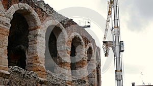 Arena di Verona, with cranes while setting up a scene inside, a destination for tourists looking for romance and