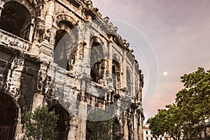 Arena of Nimes at sunrise and moonset