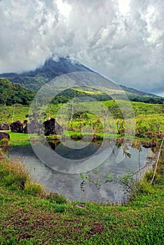 Arenal Volcano, Costa Rica, reflected in a lake on a hiking trail up the mountain