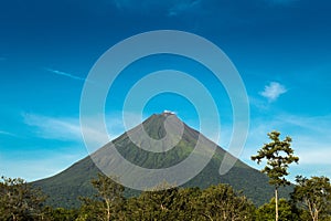 Arenal Volcano view in a sunny day with blue sky and green nature photo