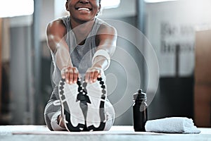 These arent just for ballet. a young woman doing stretches and exercising at the gym.