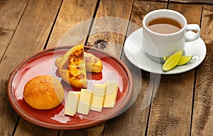 Arepa, almojabana, cheese and hot aguapanela - Typical Colombian breakfast