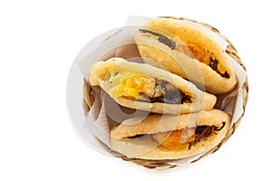 Arepa de huevo. Traditional Colombian fried arepa filled with egg and shredded meat on white background