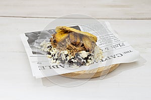 arepa pabellon with lots of fresh cheese, shredded pork and pieces of ripe banana