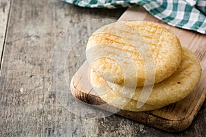 Arepas on wooden table. Venezuelan typical food photo