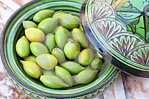 Argan nuts in a green plate.