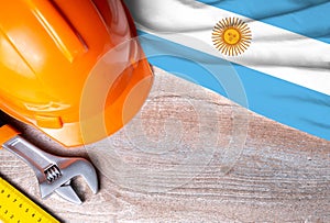 Argentina flag with different construction tools on wood background, with copy space for text