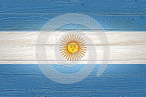 Argentina flag painted on old wood plank background. Brushed natural light knotted wooden board texture. Wooden texture background