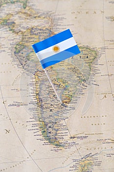 Argentina flag pin on a world map