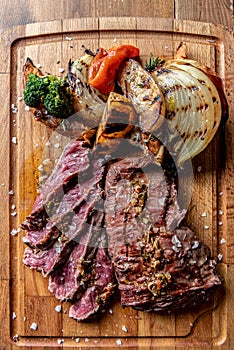 Argentine cut of meat called Vacio with chorizos and chimichurri photo