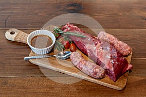 Argentine cut of meat called Vacio with chorizos and chimichurri photo