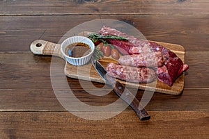 Argentine cut of meat called Vacio with chorizos and chimichurri photo