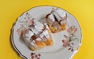 Argentine factura (sweet bakery) filled with dulce de leche (milk caramel) for breakfast or tea time photo