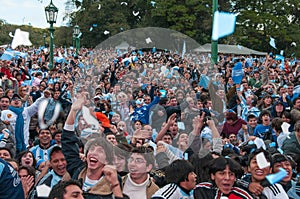 Argentine football fans celebrate their 2010 World Cup victory over Greece in front of a huge screen