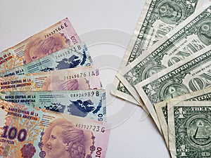 argentinean banknotes and american one dollar bills photo