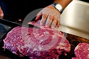 Argentinean raw beef steak meat is cut, sliced