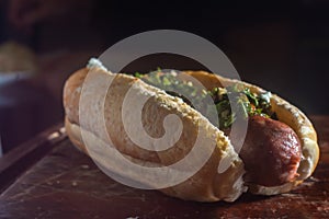 Argentinian choripan. bbq hot dog witch chimichurri sauce and Italian bread