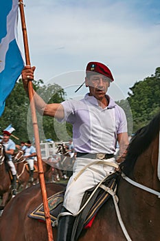 Argentinian Gaucho in a parade holding a flag