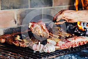 Argentinian meat roasting on the grill. Making a traditional barbecue called Asado in Argentina